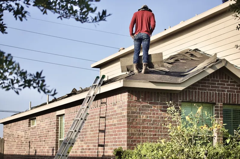 Professional roofer working on a residential roof in Rehrersburg